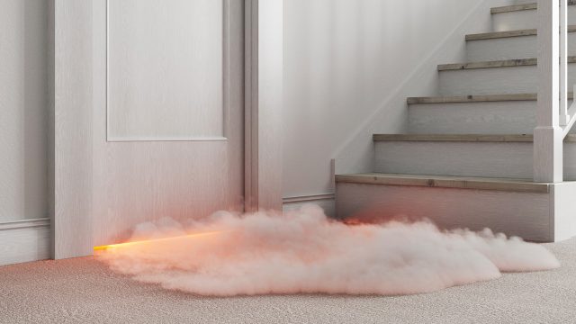 Smoke at the bottom of a door near stairs